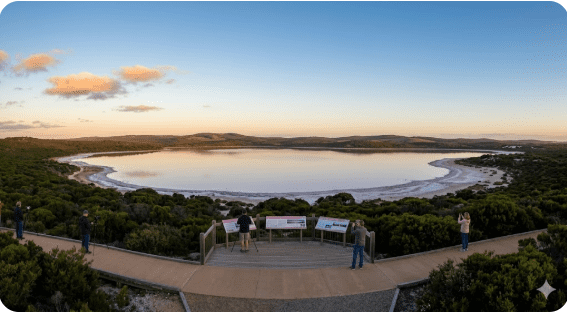 wilight Beach Esperance WA, white sand and turquoise waters at sunset, people walking along beach, shaded car park visible.